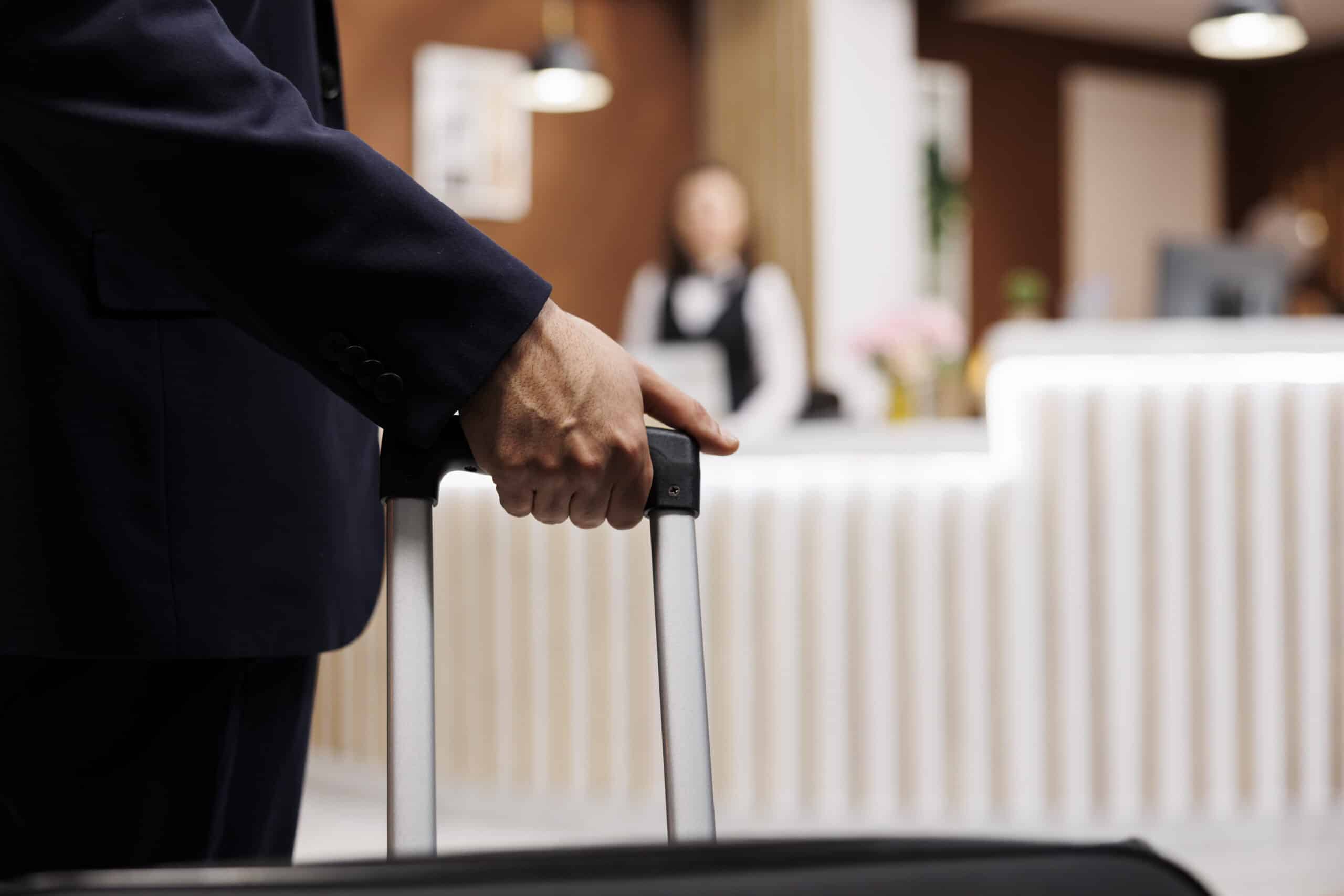 hotel guests hand holding luggage in lobby of riverside ca hotel
